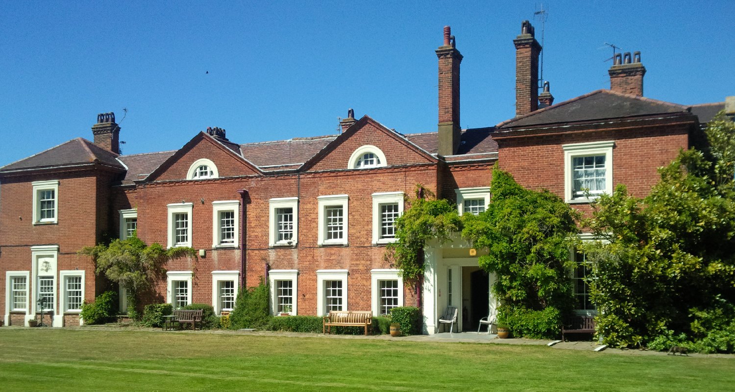 The manor house and its lawn on a sunny afternoon